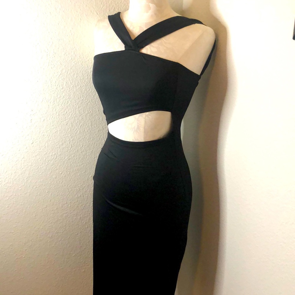 Black form fitting midi length dress with cut outs